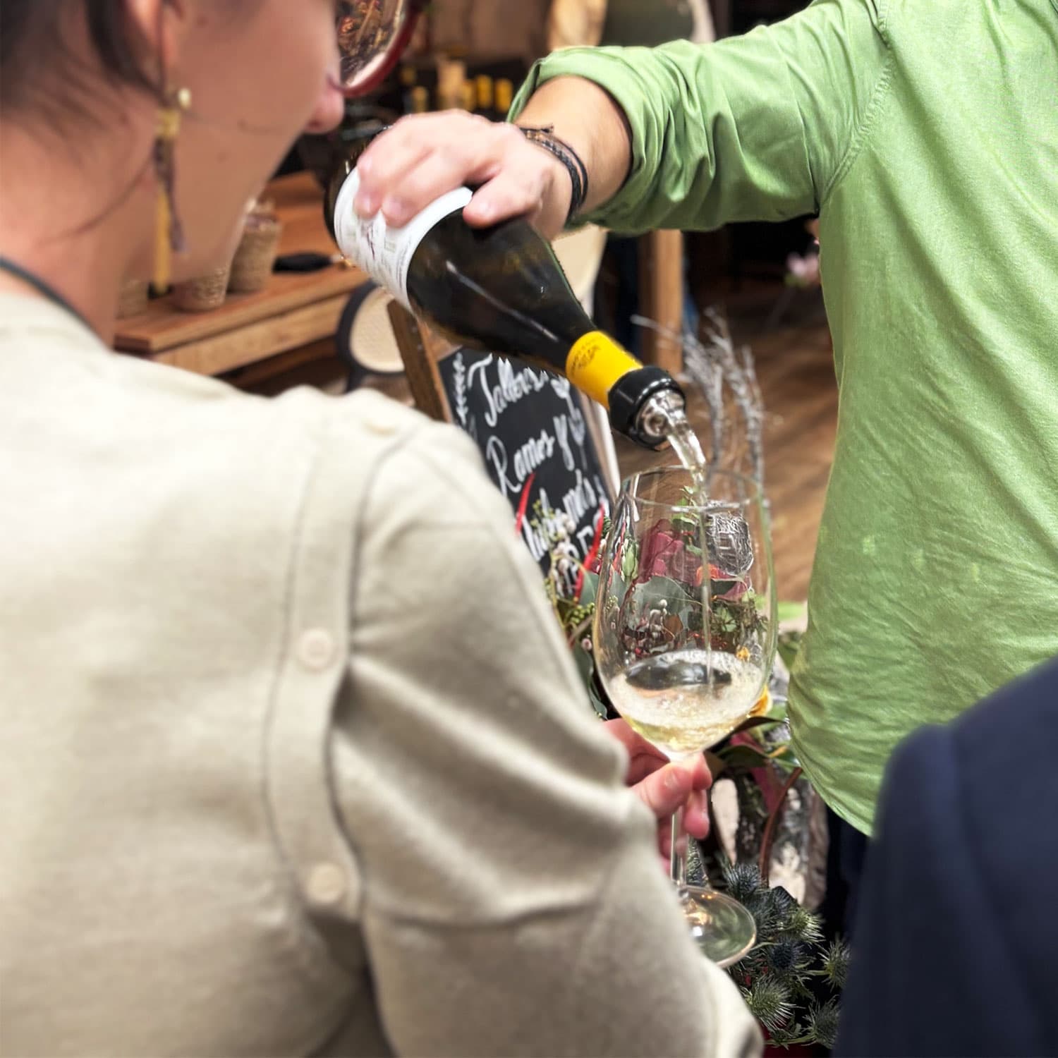 Participantes analizando los aromas florales de una copa de vino español durante la cata sensorial en Lumea Blooms Madrid.
